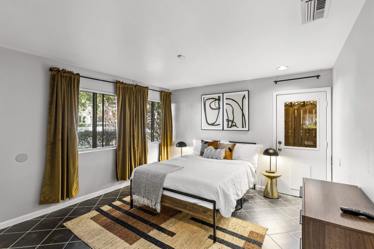 Queen bedroom with gold curtains
